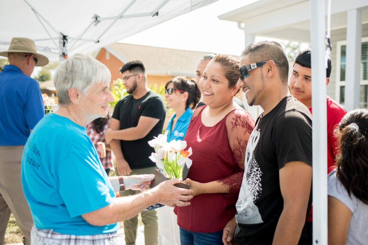 Dedication Ceremony A family celebrates their home dedication with Habitat volunteers